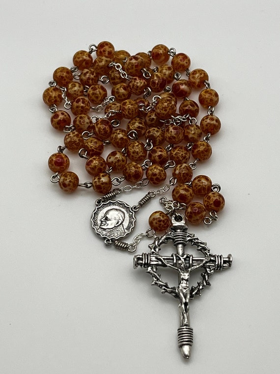 23.5" orange speckled bead rosary with JPII/Holy Spirit center and nails crucifix