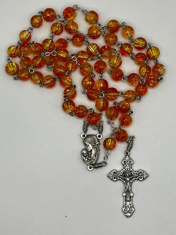 21" orange/yellow two tone crackle glass bead rosary with Madonna and Child center and ornate cross