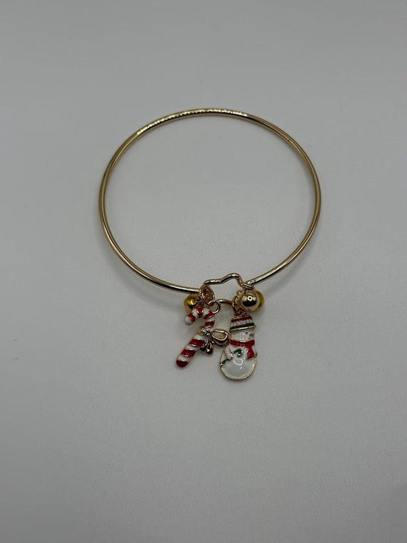 7.5" gold bangle bracelet with snowman, jingle bells, and candy cane charms