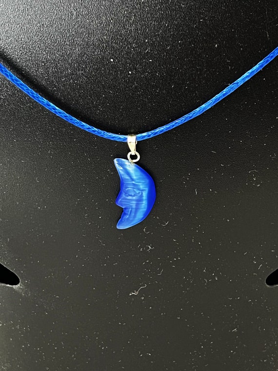 18" blue cat eye pendant on blue cord