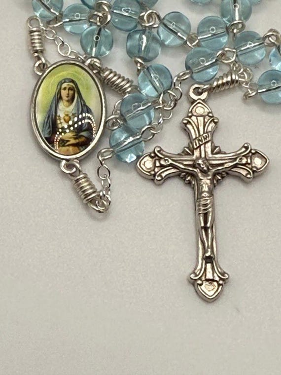 22" ice blue glass bead rosary with 7 Sorrows center and Vatican crucifix