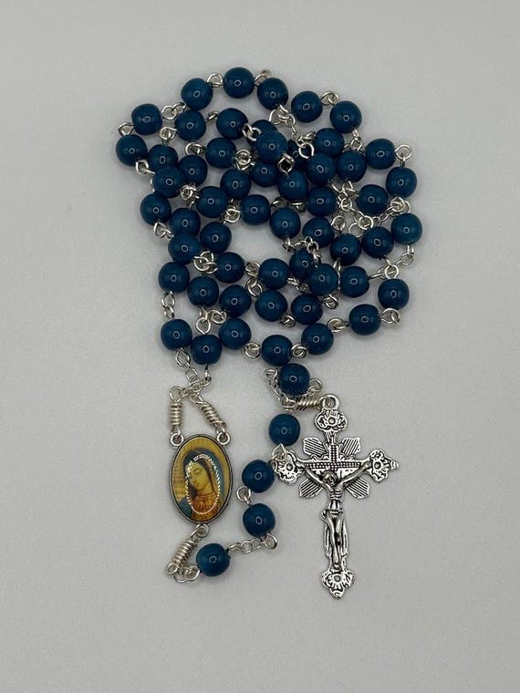 23.5" blue glass bead rosary with Our Lady Guadalupe center and renaissance crucifix