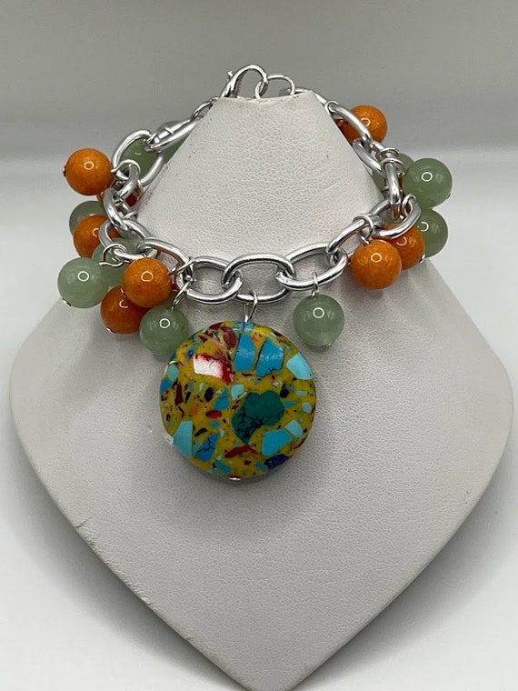 6" green and orange bead and colorful drop bracelet