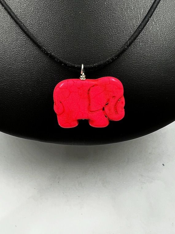 18" carved pink howlite elephant pendant on black rubber cord