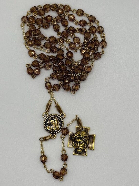26.5" brown glass bead 7 decade crown rosary with Madonna/rose center and Holy Face of Christ crucifix