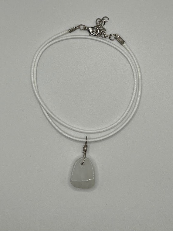 Snowy quartz or glass pendant on white cord