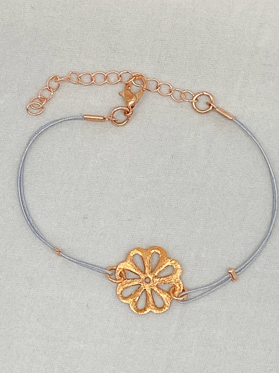 7.5" copper flower on blue cord bracelet