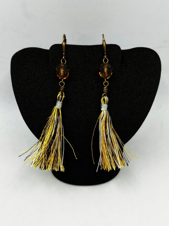 Gold, black, and white tassel earrings