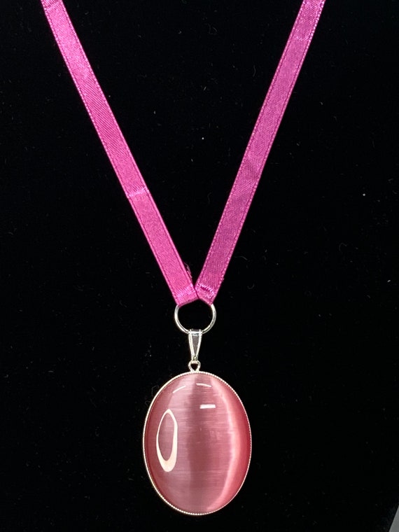 18" pink cat's eye pendant on ribbon