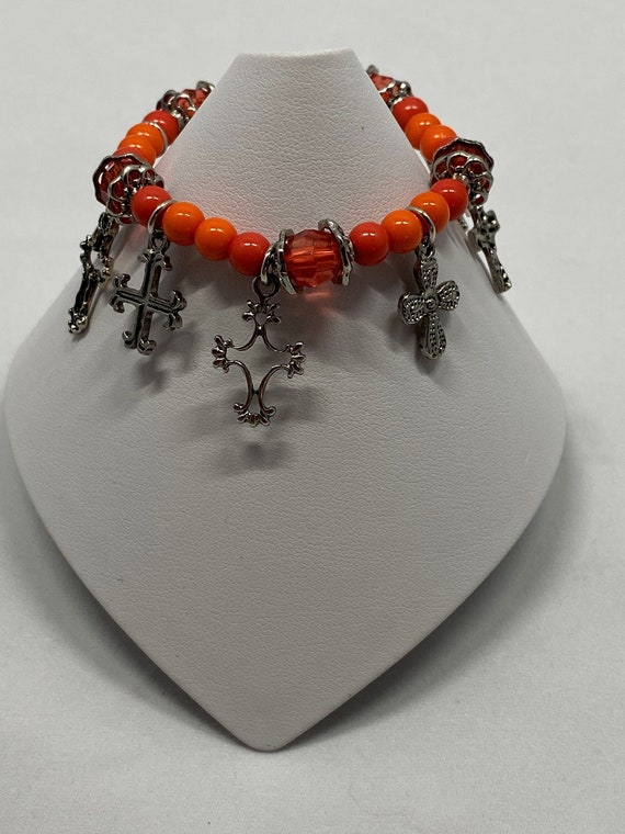 6" cross and orange bead stretch bracelet