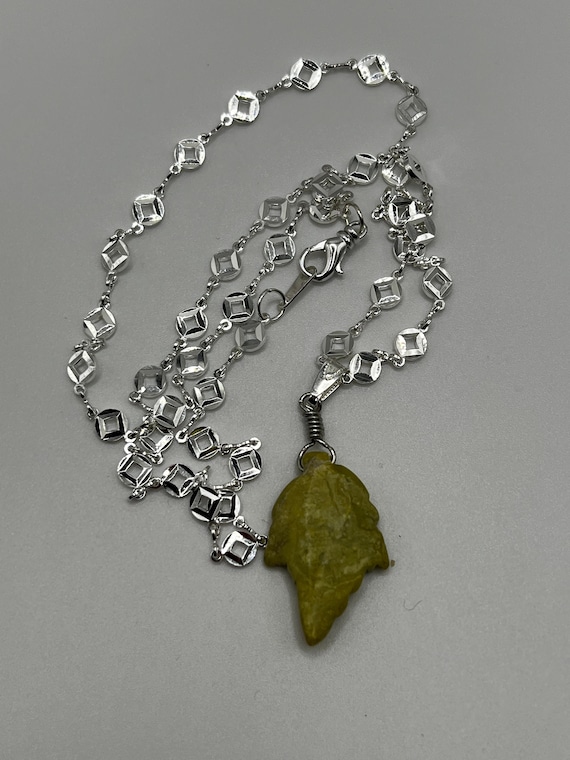 23" serpentine carved leaf pendant