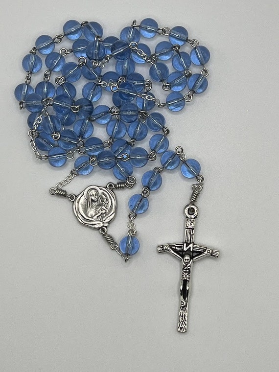 23.5" blue glass bead rosary with St Therese of Lisieux relic center and woodgrain crucifix