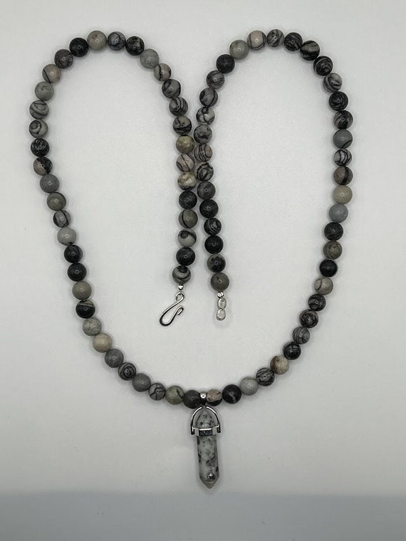 26" black silkstone beaded necklace with 'sesame jasper' point