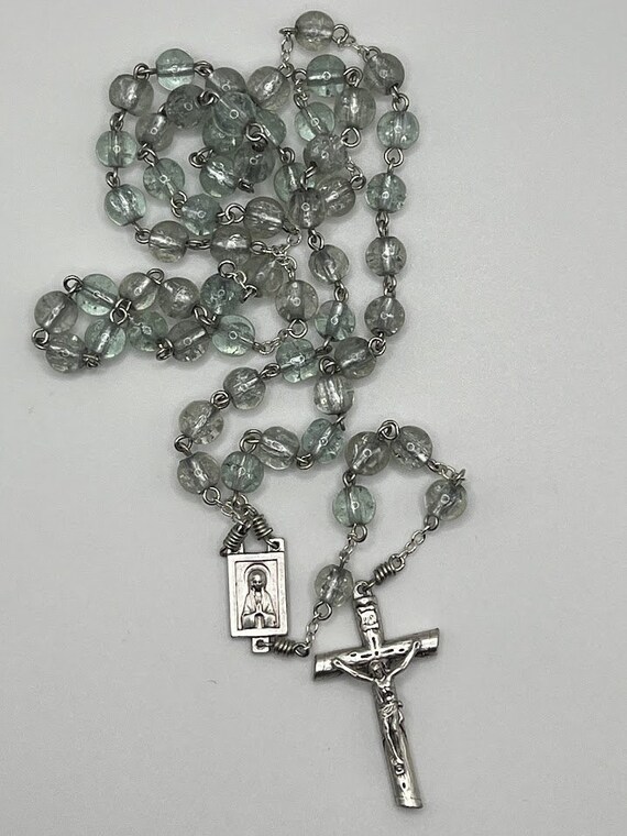 21.5" ice blue glass bead rosary with Madonna center and half round crucifix