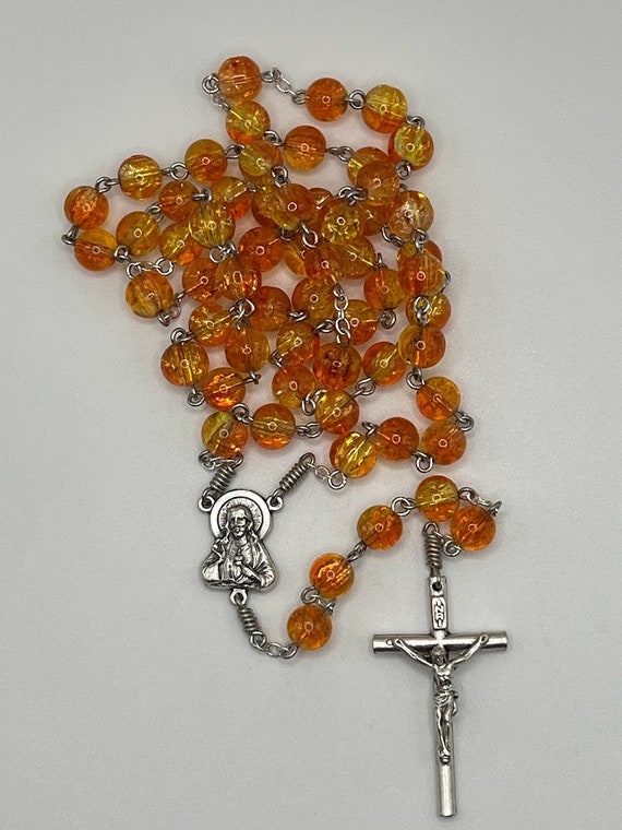 21" orange and yellow crackle glass bead rosary with Sacred Heart center and round crucifix