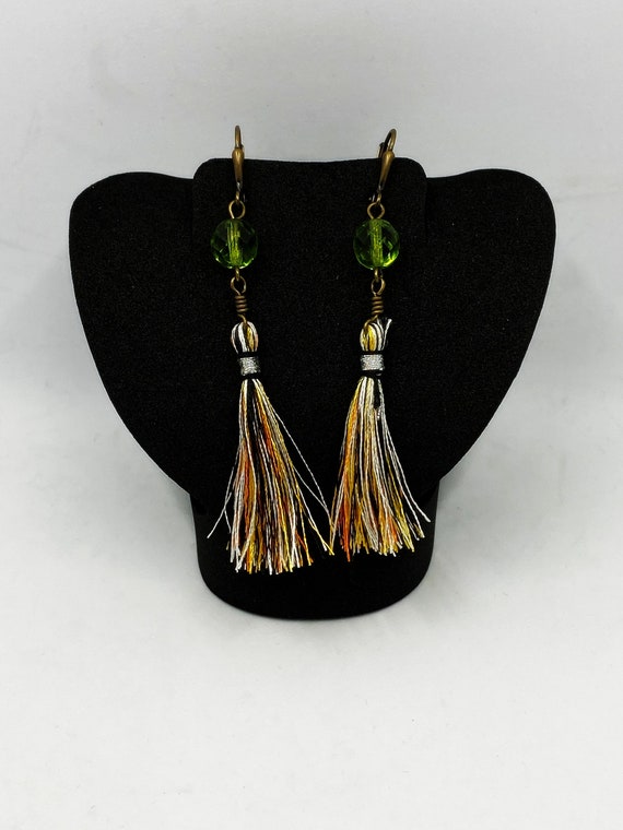 Gold, orange, black, and white tassel earrings