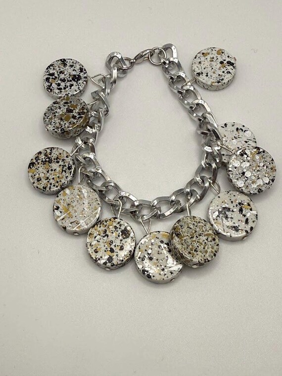 8" white 'splatter' coin charm style bracelet