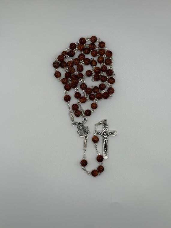 21.5 carved wooden bead rosary with St Michael center and Fatima crucifix