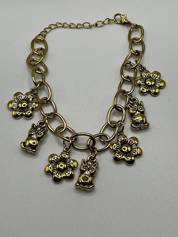7.5" gold flower and owl bracelet with 2" extender