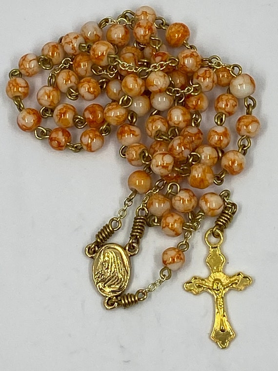 18" orange marbled bead rosary on gold with Madonna/Sacred Heart center