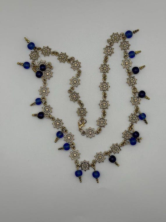 23" gold captain's wheel and blue glass necklace