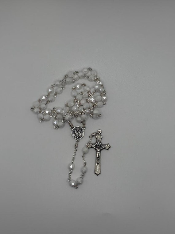 20.5 white glass bead rosary with St Rita center and white enamel inlay crucifix