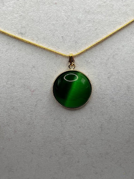 Green cat's eye pendant on 18" gold snake chain