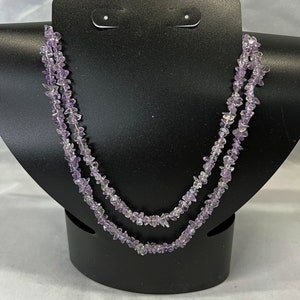 May include: A double strand necklace made of light purple amethyst chips.