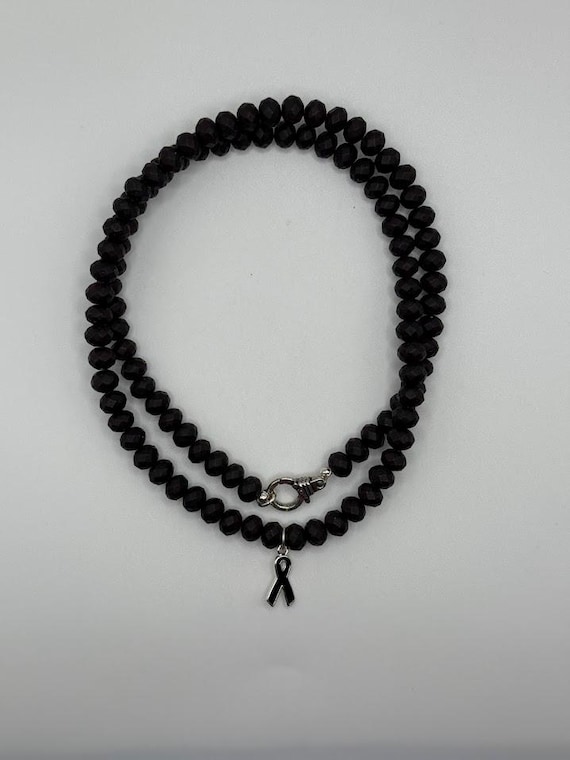 26" black rubber coated bead necklace with awareness ribbon
