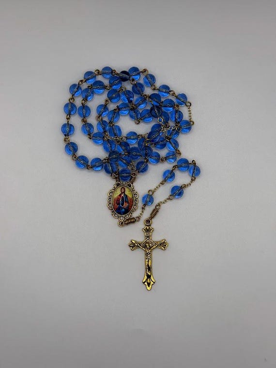 23.5 " blue glass bead rosary with Jesus the Teacher center and fluted tips crucifix