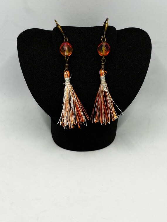 Orange, black, and white tassel earrings