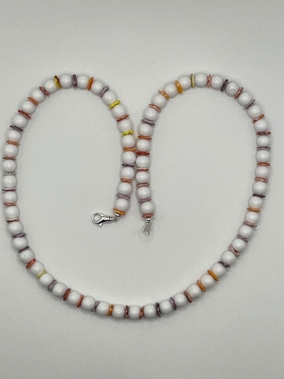 23" white bead necklace with red, orange, purple, and yellow accents