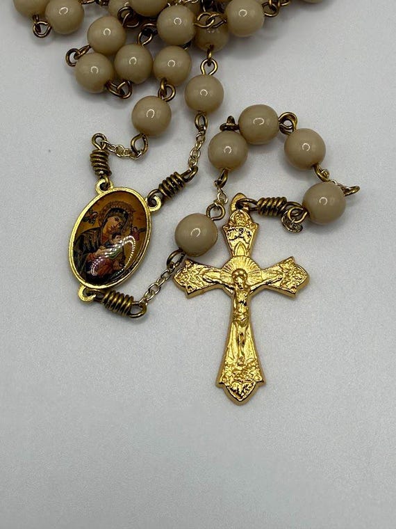 24.5" beige glass bead rosary with Our Lady of Perpetual Help center and leaves and grapes crucifix