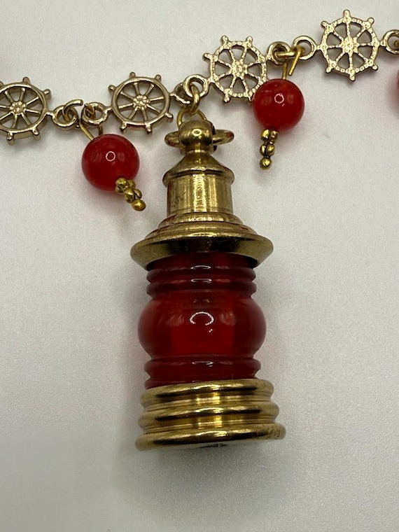 23" ship's wheel and red glass bead necklace with lantern pendant