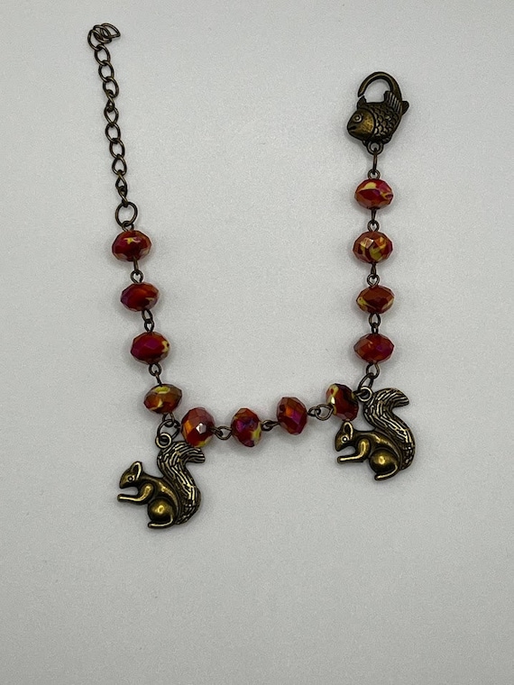 7" red/yellow bead and squirrel charm bracelet with 2" extender