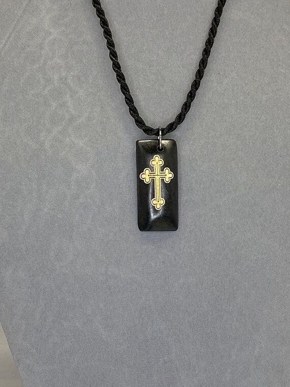 18" black cord necklace with cross or carved drop