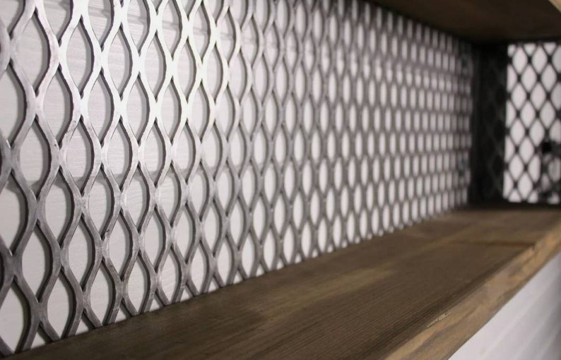 May include: A close-up of a wooden shelf with a metal mesh backing. The mesh is a diamond pattern with a silver finish.