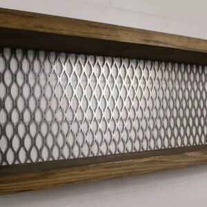 May include: A wooden shelf with metal sides and a wire mesh back. The shelf is mounted to a wall and has two shelves.