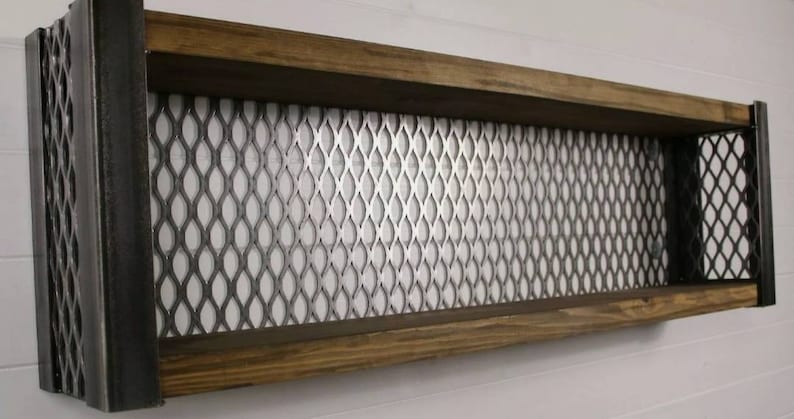 May include: A wooden shelf with metal sides and a wire mesh back. The shelf is mounted to a wall and has two shelves.
