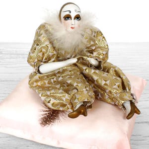 May include: A set of three ceramic mugs with a speckled, matte finish. The mugs are in shades of cream, light gray, and dark gray. Each mug has a simple, minimalist design and a rounded handle.