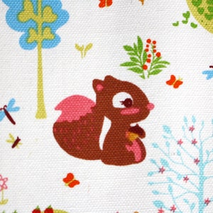 May include: A white fabric featuring a repeating pattern of a brown squirrel holding an acorn, surrounded by colorful trees in shades of green and blue, small pink flowers, orange butterflies, blue dragonflies, and a small red bird on a branch.