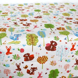 May include: A white fabric featuring a repeating pattern of woodland creatures including brown squirrels, orange foxes, and blue raccoons, interspersed with colorful stylized trees, small snails, birds, and various floral elements.