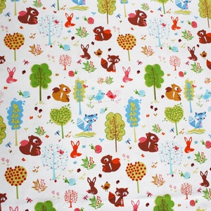 May include: A white fabric featuring a repeating pattern of brown squirrels, blue foxes, pink rabbits, and small birds. The design includes various stylized trees in shades of green and blue, along with small pink snails and tiny floral elements.