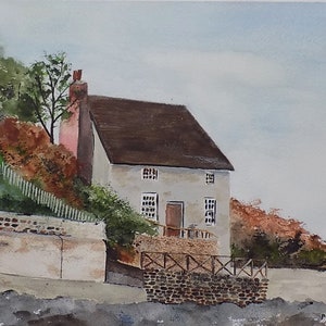 May include: Watercolor painting of a white cottage with a brown roof, surrounded by trees and a stone wall. The cottage has a wooden door and windows.
