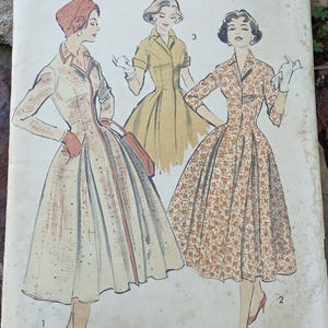 May include: Vintage Advance sewing pattern, size 16, featuring illustrations of three different dresses. The pattern is from Woman's Day and includes the text "The Easy Printed Pattern!" The cover art depicts dresses with various floral and solid designs.