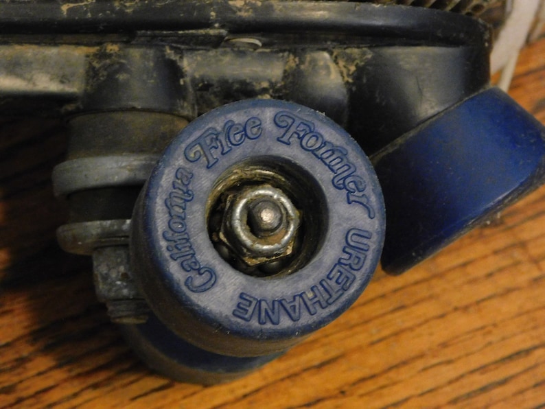 May include: Close-up of a blue roller skate wheel with the text "California Free Former Urethane" printed on it.
