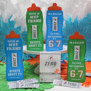 May include: A selection of Gatorade Zero products, featuring blue and green water bottles with orange lids, and Glacier Cherry powder sachets. The bottles display text such as "You're an MVP Friend" and "On a scale of 6-7".