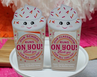 May include: Two paper cup-shaped gift card holders with a whipped cream design and the text "Our School Runs On You!" and "Thank you for all you do!" The holders are for teacher appreciation gifts.