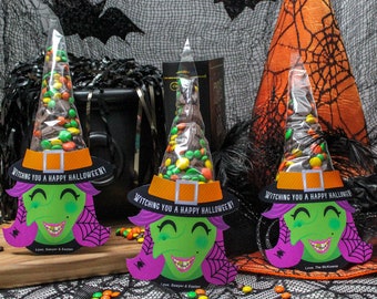 May include: Three Halloween witch-themed candy treat bags. Each bag features a green witch face with purple hair and a black witch hat filled with colorful candies. The hats have the text "Witching You a Happy Halloween!"