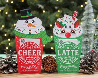 May include: Two Christmas-themed gift card holders, one with a snowman and the other with a reindeer, both holding Starbucks gift cards. The snowman holder says "Have a Cup of Cheer Winter Break is Near" and the reindeer holder says "Wishing You a Latte Holiday Cheer!" Both holders have the text "Happy Holidays! Love, The McKown Family."